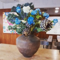 Flower arrangement, including whole artichokes
